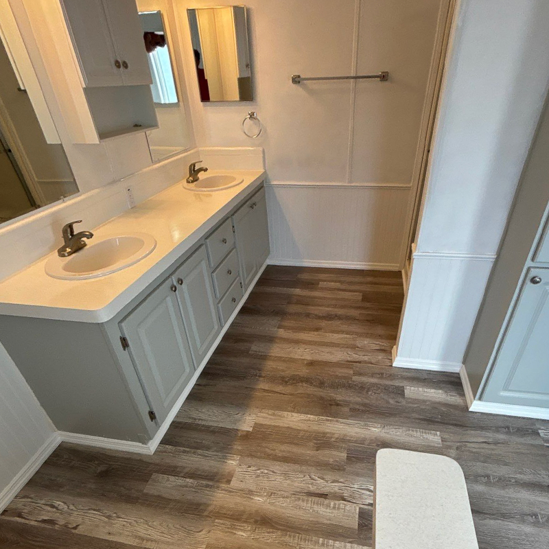 Freedom Mobile Home Services crew installing new fixtures during a mobile home bathroom upgrade.