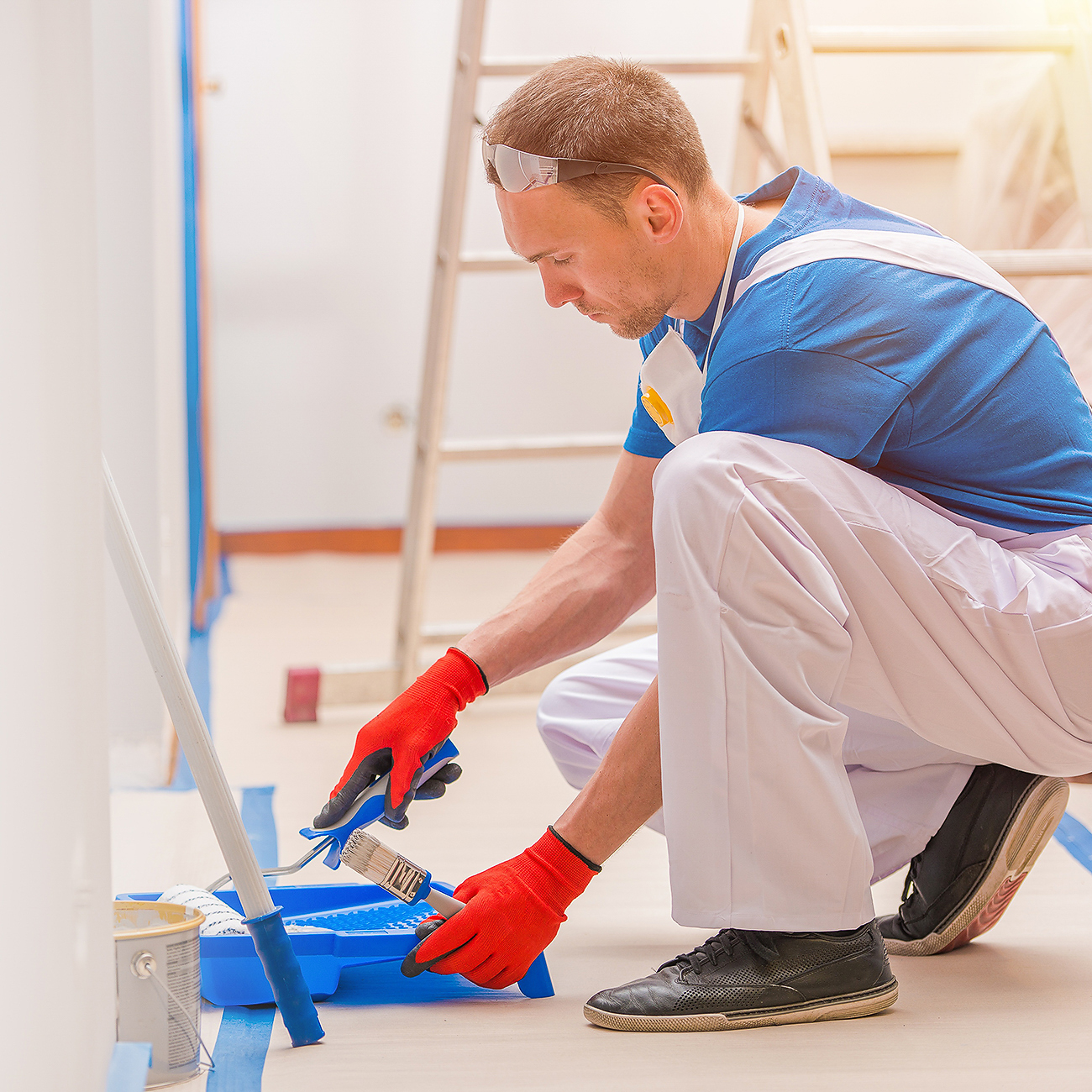 Painter applying a new coat of paint to mobile home walls for a clean, bright finish.